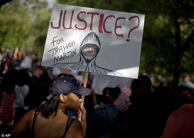 Sonia Medina, of Suwanee, Ga., holds a sign while joining a protest the day after George Zimmerman was found not guilty in the 2012 shooting death of teenager Trayvon Martin, Sunday, July 14, 2013, in Atlanta. (AP Photo/David Goldman) Read more: http://www.dailymail.co.uk/news/article-2362973/Protests-erupt-coast-coast-George-Zimmerman-goes-FREE-Second-day-demonstrations-planned-night-anger.html#ixzz2ZBLxMU6i